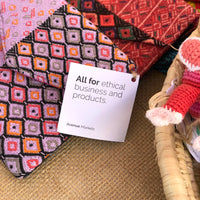 Coloured products on a table with a tag in the centre that says "All for ethical business and products"